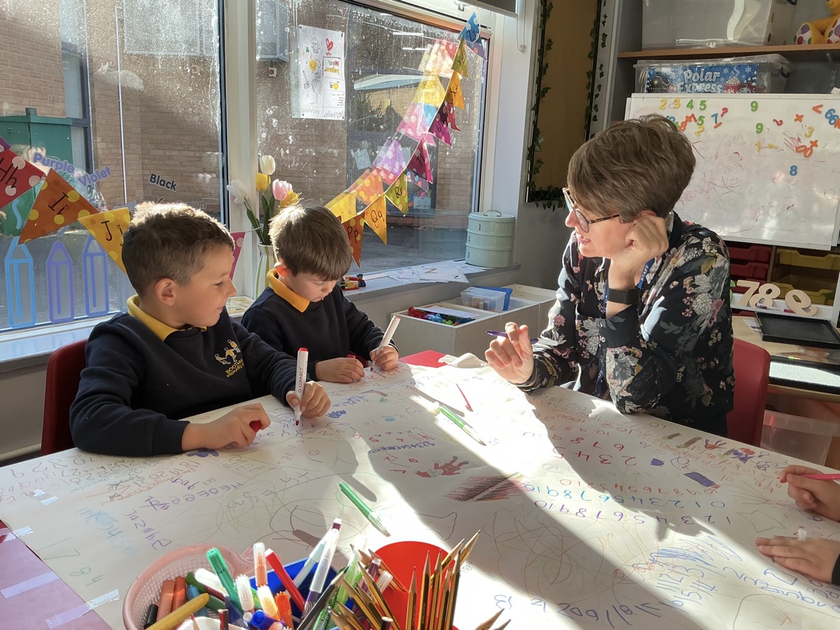The head teacher working with two pupils at Boothville Primary School.